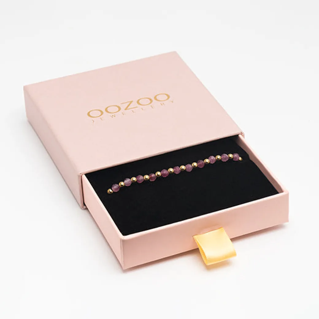 Goudkleurige armband met roze natuursteentjes