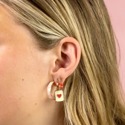 Rosé goudkleurige oorbellen met rode kraaltjes
